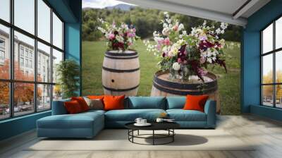 Vibrant Elegant Floral Arrangement Wedding Ceremony Decor with Pink, White Fuchsia, Purple, and Green Flowers on Wooden Wine Barrel Overlooking Mountains Outdoors Wall mural