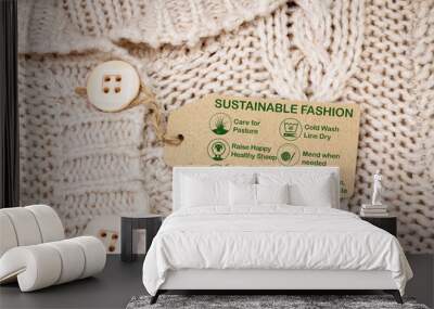 sustainable fashion label on woollen jumper with care icons and text, ethical consumerism Wall mural