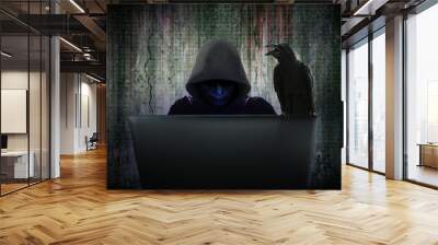 Computer cyber criminals in black mask and hood are hacking data to infiltrate and attack corporate security systems with the black crow is hanging on the computer Wall mural