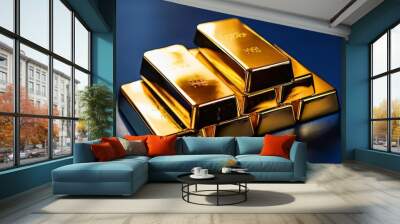 Stacked gold bars arranged in pyramid formation on reflective dark surface with deep blue background Wall mural