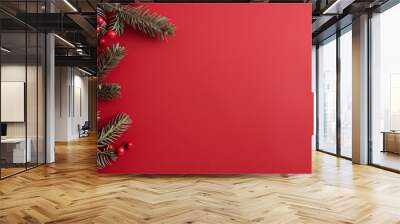 Festive Greenery and Berries on Red Background for Holiday Celebration Wall mural