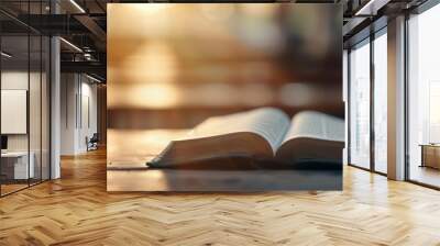 Open Bible on Wooden Table in Sunlit Room Wall mural