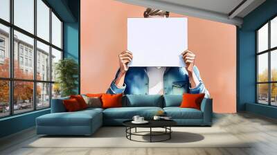 Man concealing face with blank paper Wall mural