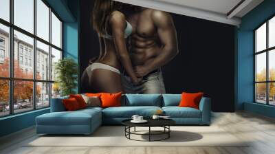 Fitness couple. Artistic portrait of young athletic  shirtless man and woman in underwear in studio Wall mural