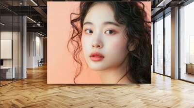 Attractive Asian beauty woman curly long hair with korean makeup style on face and perfect skin on isolated peach background. Facial treatment, Cosmetology, plastic surgery.  Wall mural