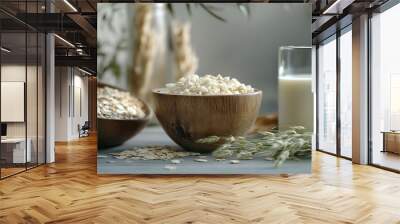 Glass with milk and oat flakes on table Wall mural