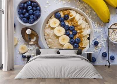 plate of oatmeal on the table in a bowl with peanut butter, coconut flakes Wall mural