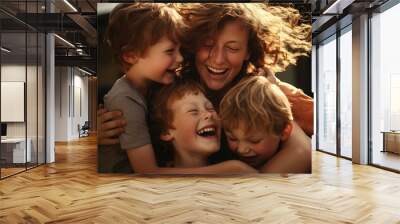 a woman is hugging three children and laughing Wall mural