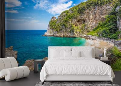 Scenic view of Fakistra beach in Pelion in Greece with the emerald water of the Aegean sea and a summer day dramatic sky Wall mural