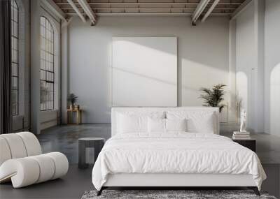 A blank white square frame was hanging on the wall of an industrial warehouse with concrete floors and high ceilings. The room was well lit, with large windows that provided natural light from outside Wall mural