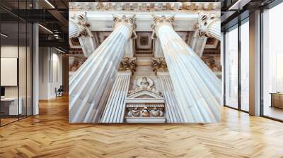 A closeup of classical Greek columns, each with intricate carvings and a soft white marble finish, standing in the center of an architectural building. Wall mural