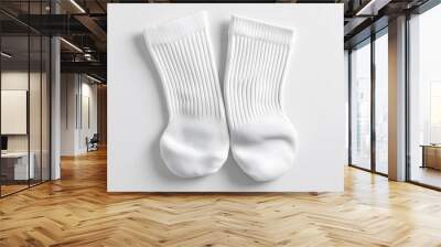 A pair of plain white cotton socks, ribbed texture, athletic style, folded neatly, top-down view, crisp details, soft shadows, minimalist composition, white background, product photography. Wall mural