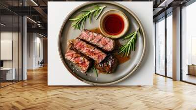 A plate of medium rare steak with rosemary and sauce, top view, for product photography, on a white background. Wall mural