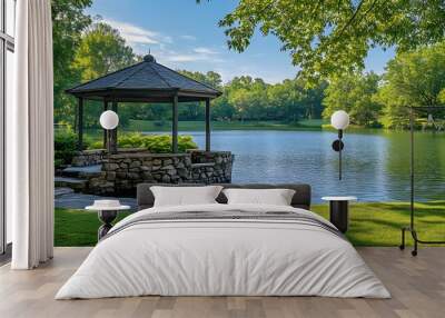 Lakeside scene with serene water reflections and a stone gazebo, set in a lush green landscape with clear blue sky, creating a tranquil outdoor setting and harmonious blend. Wall mural