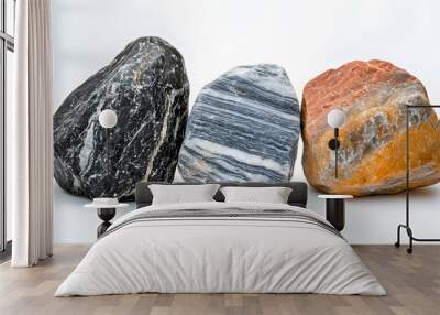 Three large rocks exhibit diverse textures and colors, including black granite and striped marble, arranged on a white background to emphasize their mineral details in high-resolution studio lighting. Wall mural