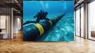 A man in a black wet suit is working on a pipe underwater. Concept of adventure and exploration, as the man is diving deep into the ocean to fix the pipe. The blue and yellow colors of the pipe Wall mural