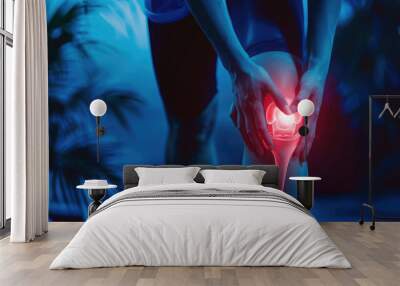 Close-up of knee pain with glowing red hip and leg on dark blue background Wall mural