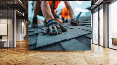 Roofer worker in special protective work wear and gloves, installing asphalt or bitumen shingle on top of the new roof under construction residential building Wall mural