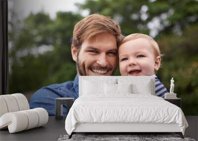 Dads pride and joy. young father and his baby boy enjoying a day outside. Wall mural