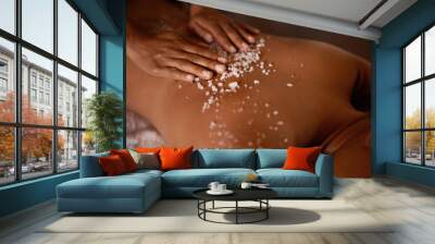 Salt, spa scrub and beauty therapist hands with woman customer at a hotel with massage. Exfoliate therapy, luxury and relax treatment of a female person back for skincare and wellness exfoliation Wall mural