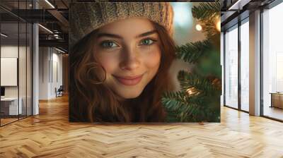 happy young girl decorating christmas tree in living room. Wall mural