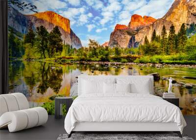 Sunset glow over El Capitan on the left and Cathedral Rocks, Sentinel Rock and Bridalveil Fall on the right and reflecting in the calm water of Merced River in Yosemite National Park, California, USA Wall mural