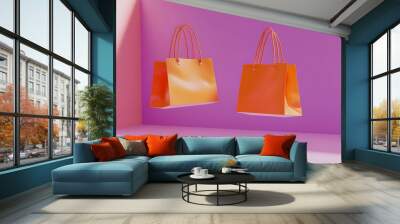 Two vibrant orange shopping bags floating against a pink background. Black Friday Deals - Wall mural