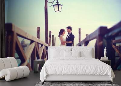 Bride and groom on wooden bridge Wall mural