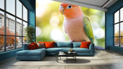 A vibrant pink parrot rests on a branch, surrounded by soft green foliage. The scene captures the bird's colorful plumage in bright sunlight, showcasing its beauty Wall mural