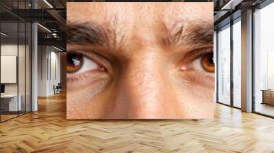 Detailed close-up of a young mans face showing his captivating brown eyes and features Wall mural