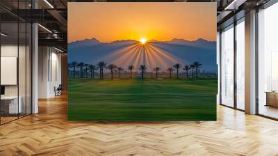 Sunrise over mountains and palm trees on a golf course, highlighting serene beauty in early morning light Wall mural