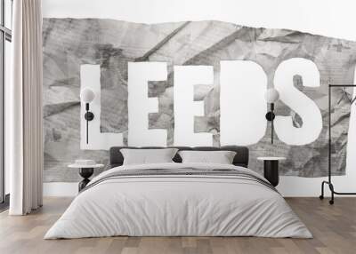 Leeds city name cut out of crumpled newspaper in retro stencil style isolated on transparent background Wall mural