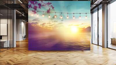 blurred bokeh light on sunset with yellow string lights decor in beach restaurant Wall mural