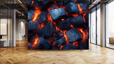 Smoldering charcoal glows vibrantly, cracking under the intense heat of flames Wall mural