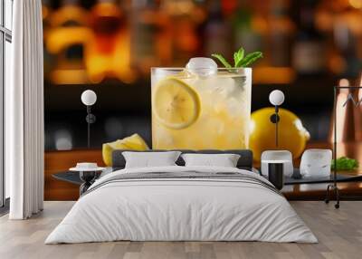 Chilled cocktail with ice and lemon served on a stylish bar counter Wall mural