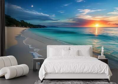 Tranquil beachscape featuring soft sand, vibrant turquoise water, and a stunning sunset casting elongated shadows across the serene shoreline Wall mural