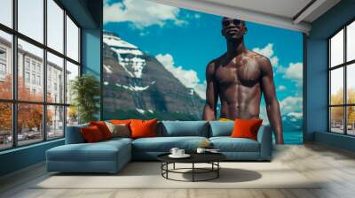 Black muscular male, shirtless wear swim trunks and sunglasses Wall mural