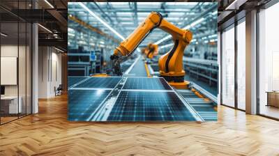 An orange industrial robot arm is featured at the production line in a modern bright factory where solar panels are assembled on a conveyor in an automated manufacturing facility Wall mural