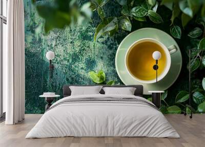 Cup of fresh green tea with tea leaves. Flat lay, top view. Wall mural