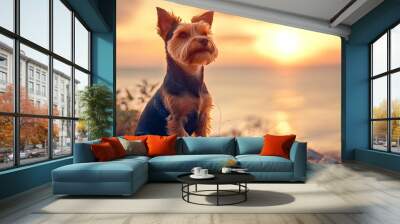 Portrait of welsh terrier dog sitting at sea shore at sunset. Wall mural