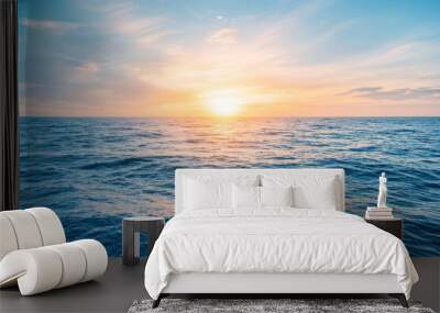 Scenic view of endless ocean with horizon line under bright sunset sky in evening time. Wall mural