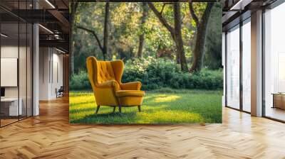 Vintage yellow chair on green grass with trees on background. Wall mural