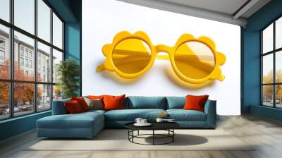 Yellow flower-shaped sunglasses on a white background. Wall mural