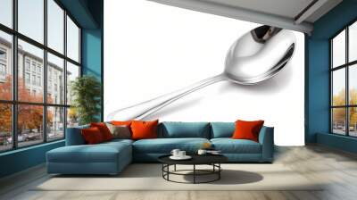 Gleaming silver spoon stirring dreams in a cup of tea, isolated on white solid background Wall mural