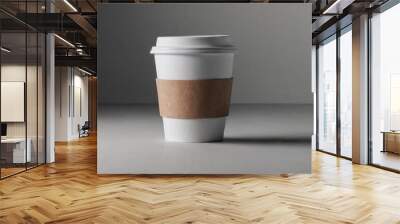 A minimalist coffee cup mockup. The white cup with a brown sleeve sits on a neutral background, perfect for branding and design projects. The clean, simple design highlights the cup's shape Wall mural