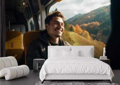 Happy, smiling young man traveling in train. Wall mural