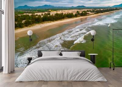 Beach scene with waves crashing on the golden sand are so beautiful from above, the beach is for relaxing and bathing Wall mural