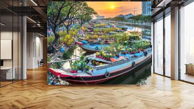 Flower boats full of flowers parked along canal wharf in sunset, a place for bustling flower market trade lunar new year in Ho Chi Minh City, Vietnam Wall mural