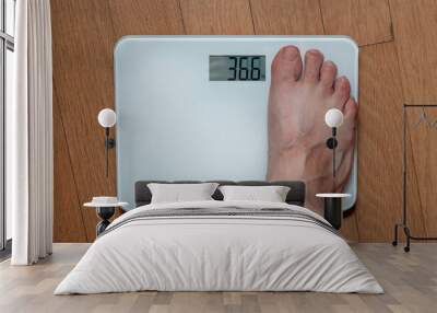 A person measuring weight on a scale Wall mural