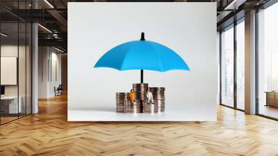 A miniature old man and a miniature old woman sitting on a pile of coins. The concept of post-retirement financial design. Wall mural